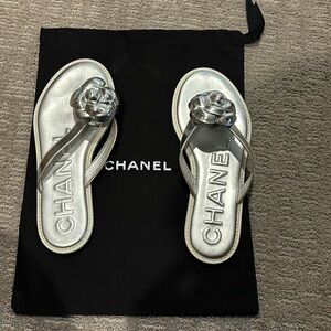 Chanel silver camellia white rubber sole flip flops.